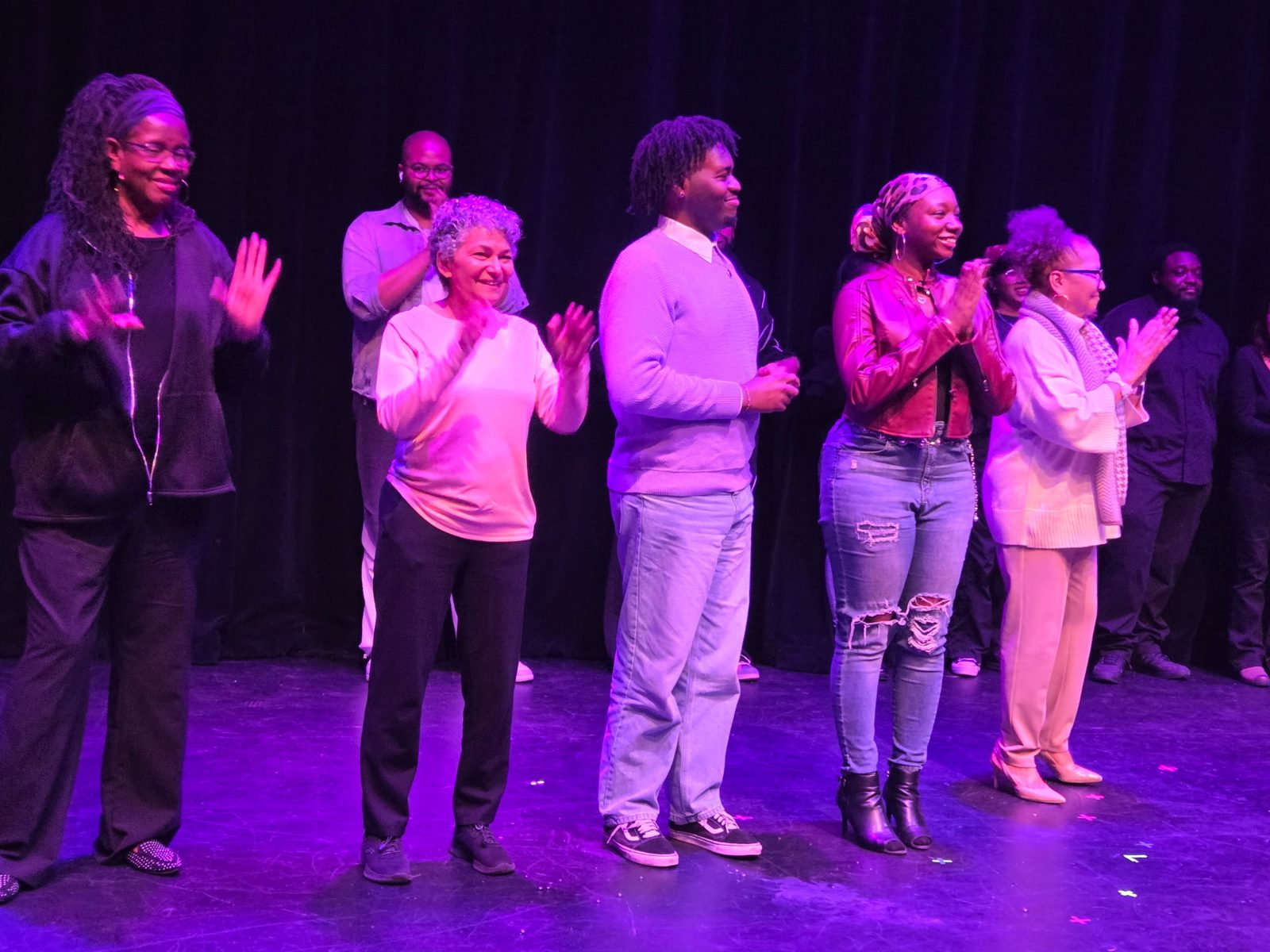 Melanie Payne taking a curtain call with the cast of one of her plays